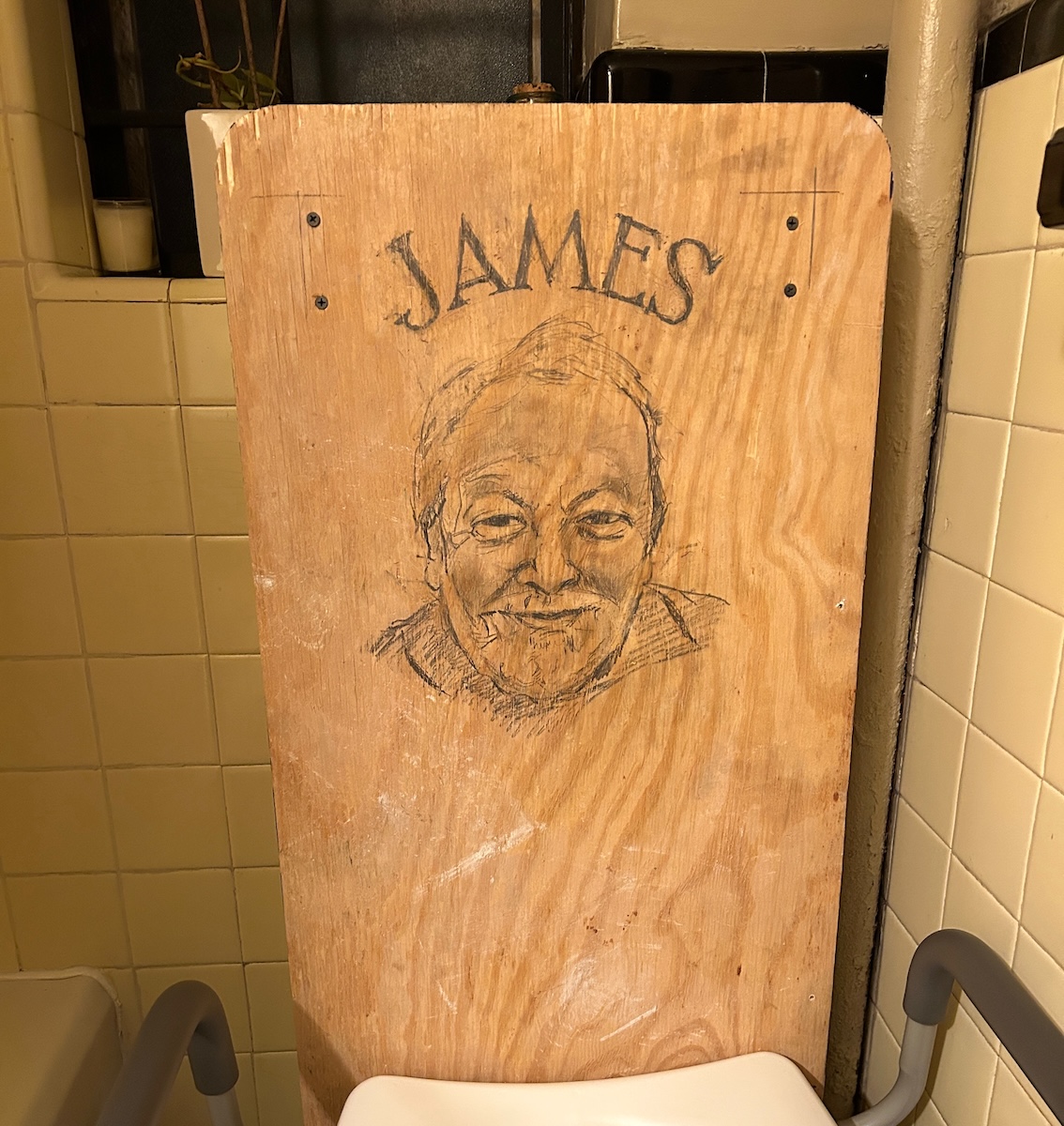 Toilet back with drawing of James
